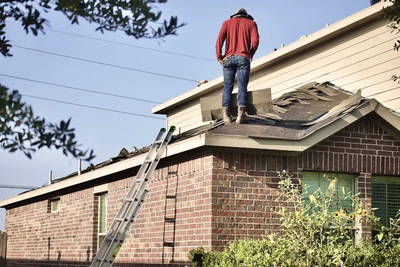 Professional roofer working on a residential roof in Grand Terrace